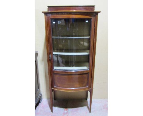 An inlaid Edwardian mahogany display cabinet of bow fronted outline on square tapered supports, 155cm high x 64cm x 42cm