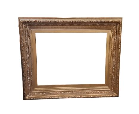 A large 19th century gilt gesso picture frame with moulded laurel leaf decoration, interior dimensions: 64 x 85 cm, frame dim