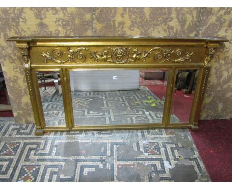 A contemporary reproduction Regency style overmantle mirror of rectangular form, the decorative gilt frame with pseudo Egypti