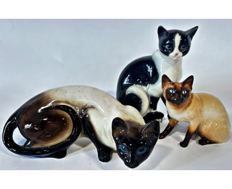 Three cat figures to include a Goebels example, a Sylvac example, and one other, together with Dutch Jema stretched neck dogs