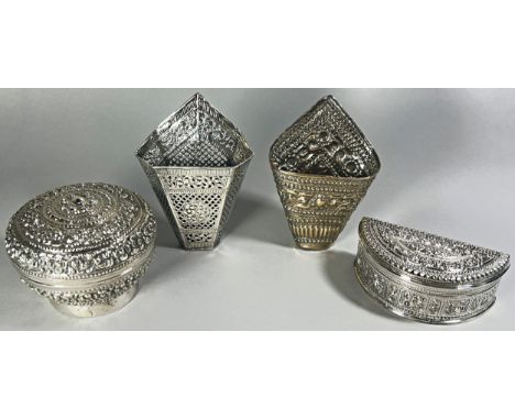 A mixed selection of Thai silver, including two open kite shaped Betel holders, a richly engraved circular Betel box and a cr