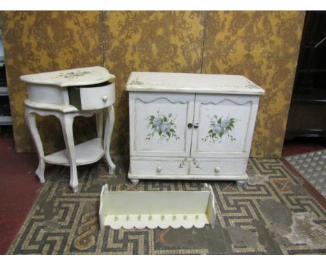 A low side cupboard enclosed by a pair of shaped panelled doors over two drawers with decorative all over painted finish, 67 