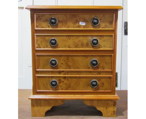 A miniature chest of four drawers with burr walnut veneers, a gilt framed mirror, further inlaid mahogany toilet mirror and a