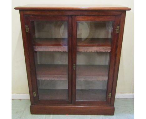 A small glazed mahogany bookcase with two fitted shelves 