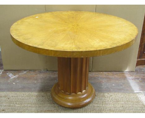 An art deco period centre and dining table, the top with segmented veneers, raised on a fluted column and moulded base, 107cm