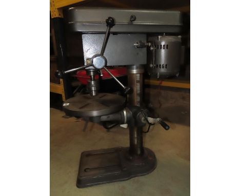 A Tull International twelve speed electric powered drill press 