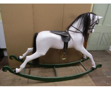 A traditional Victorian style rocking horse, the moulded body raised on boat shaped rockers, 190cm long x 125cm high