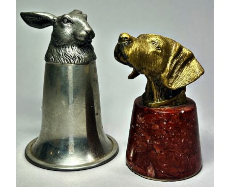 A cast metal desk weight in the form of a hound's mask on polished marble base, 9cm high, together with a cast pewter stirrup