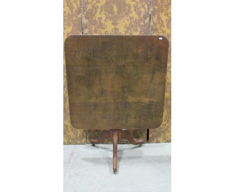 A 19th century oak tilt top occasional table, the square top with rounded corners raised on a turned pillar with swept and mo