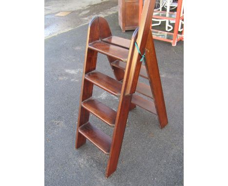 A folding mahogany library ladder, 77cm high to top tread