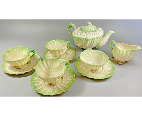 A Belleek second period porcelain ‘Neptune’ pattern porcelain part tea set, comprising teapot, sugar bowl, three cups and fou