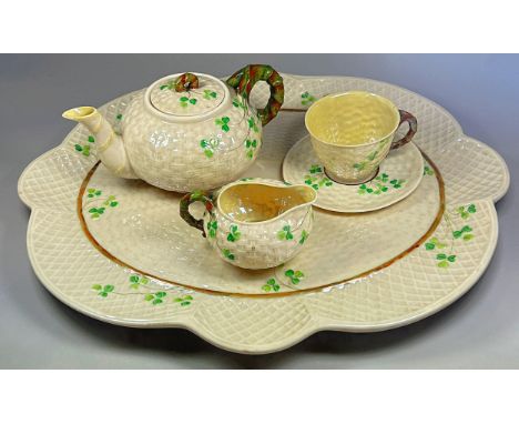 A Belleek Shamrock pattern second period cabaret set comprising shaped tray, teapot, milk jug and single cup and saucer, toge