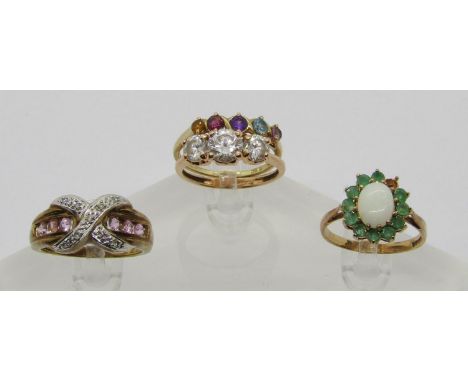 Four gold gem set dress rings comprising a 14ct cubic zirconia example, a 9ct diamond 'X' design example channel set with pal