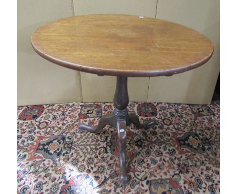 A Georgian mahogany snap top table the circular top raised on a vase shaped pillar and well shaped  tripod base, 75cm diamete