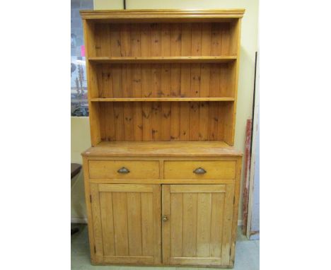 A 19th century stripped and waxed pine kitchen dresser with two drawers and two frieze drawers with plate rack over, 208cm hi