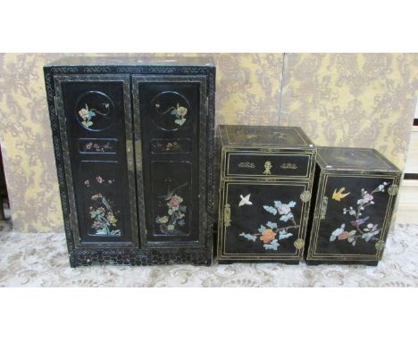 A Chinese side cupboard enclosed by a pair of full length rectangular panelled doors with decorative floral, bird and branch 