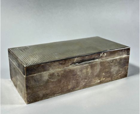 A silver cigarette box, Sheffield 1931, makers mark Walker &amp; Hall, 18cm wide