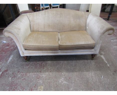 A small two-seat club sofa raised on turned legs with rolled arms, 165cm wide