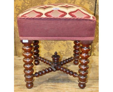 A Victorian stool with square stylised tapestry upholstered seat raised on mahogany turned bobbin supports and stretchers, 42