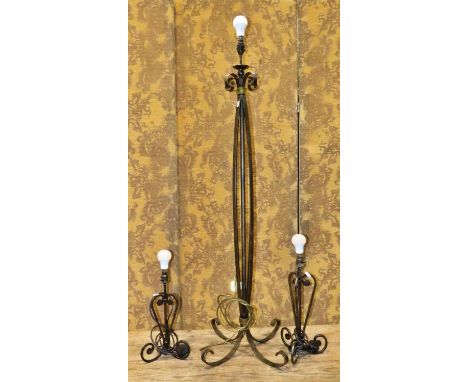 A contemporary iron work standard lamp with open scrolled strapwork construction together with two similar table lamps comple