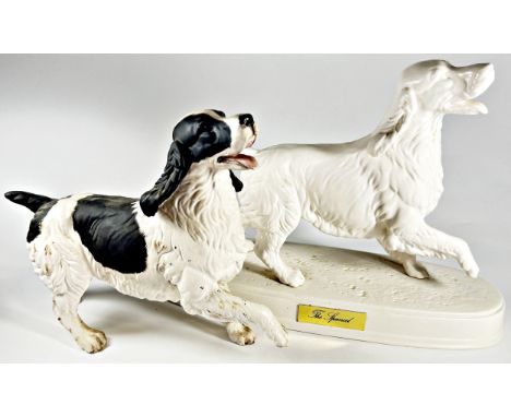 Five ceramic models of dogs in various poses including a Beswick white matt example of a Spaniel, a Beswick Pointer on a cera