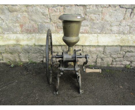 A Parnall &amp; Sons Ltd Bristol cast iron counter top coffee grinder with brass funnel, 75 cm high, the wheel 52 cm diameter