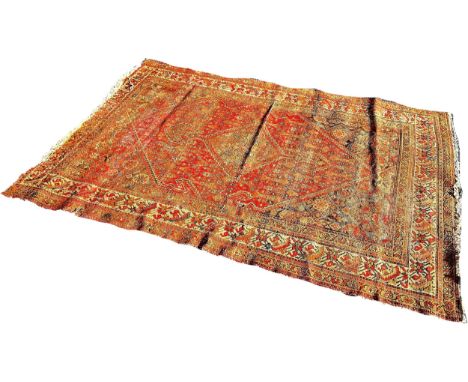 An old Persian rug with an extended central medallion , faded and worn, 190cm x 130cm approximately