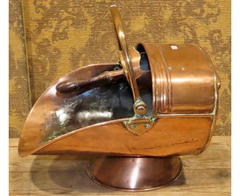 A 19th century copper helmet shaped coal scuttle complete with scoop 