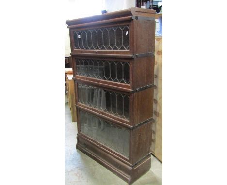 A Globe Wernicke oak floorstanding four sectional library bookcase enclosed by rectangular up and over leaded glazed panelled