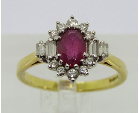 18ct oval ruby and diamond cluster ring with baguette-cut shoulders, maker 'ST', London 1988, size M/N, 3.8g