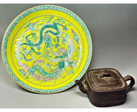 Two Chinese ceramic items, to include: A yellow-ground 'dragon and phoenix' dish with six-character Yongzheng mark in undergl