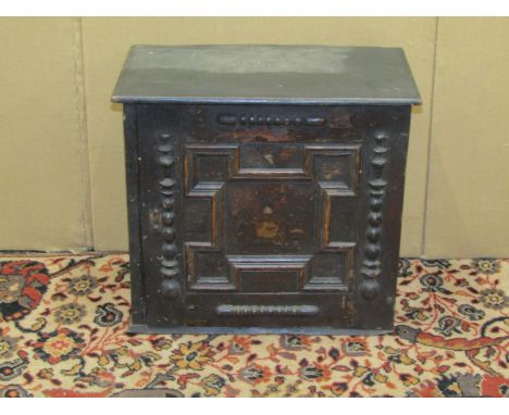 An 18th century oak spice cupboard, enclosed by a block moulded door with applied moulded detail, the interior enclosing eigh