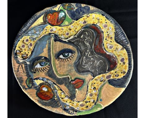 An unusual 20th century African studio ware bowl, decorated with a stylised ladies face, after Picasso, inscribed to undersid