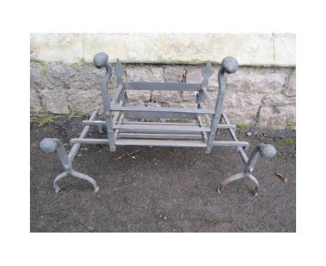 An iron work fire basket of rectangular form with loose dogs and mushroom shaped finials, 34 cm high x 64 cm wide