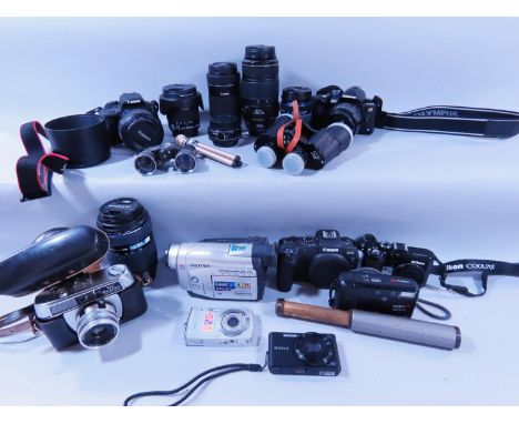 A quantity of early digital cameras, video recorders, lenses, an old Halifax camera, a pair of binoculars, and other photogra