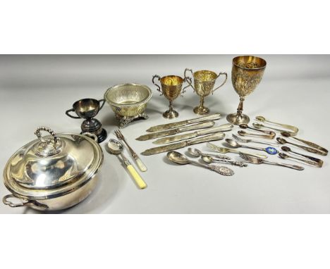 A selection of silver plate including a muffin dish, a finger bowl with a glass liner, four trophies, and a selection of loos