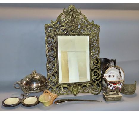 A miscellaneous collection of items including a scrolled metal mirror, a pewter tankard, a stainless steel letter opener, fli