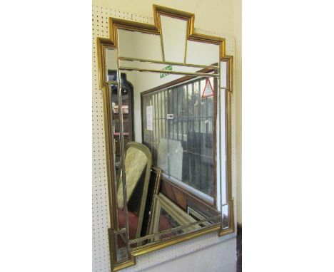 A good quality large contemporary gilt framed wall mirror in the Art Deco manner enclosing numerous segmented bevelled edge p