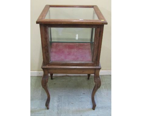 A small two tier vitrine on shaped supports, 81cm high x 47cm square