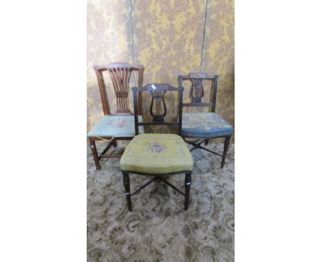 A pair of Georgian mahogany dining chairs, the carved and moulded lyre shaped splats with wheat sheaf detail, within reeded f