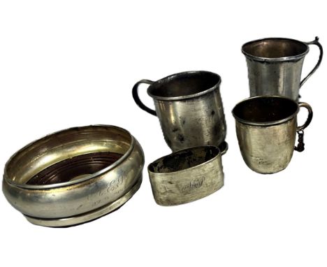 Two small silver cups, a silver wine coaster, a napkin ring, a silver plated cup, 9.5 oz all in