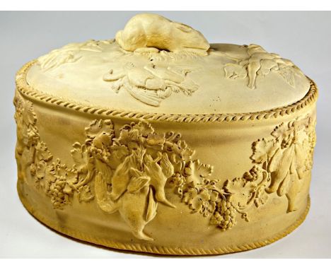 A Wedgewood cane work pie dish decorated in relief with birds, hares, grape and vine swags and with hare shaped knop