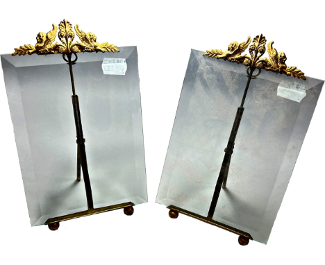 A pair of bevelled glass photo frames, with gilded sphinx mounts and easel stand 22cm high.