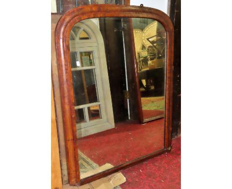 A Victorian walnut over mantel mirror, the moulded arched frame with banded detail, 110cm x 86cm (af Lacks one bracket)