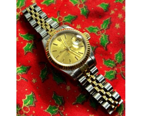 Rolex: A lady’s Oyster Perpetual Datejust wristwatch, the gold dial with baton markers, 24mm case, on two-tone Rolex strap st