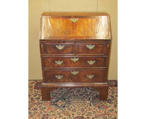 A small 18th century walnut ladies writing bureau of two long and two short drawers on brackets supports, the fall flap enclo