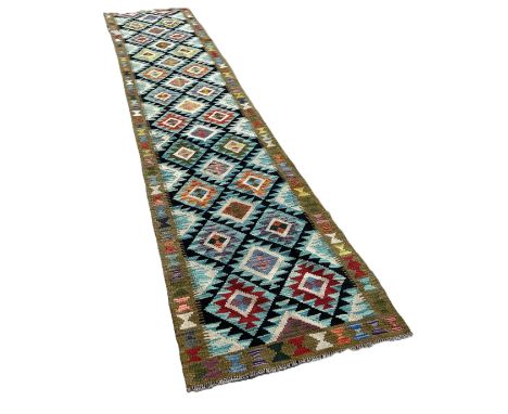 A Maimana runner with alternating rows of diamonds on a dark ground 399cm x82cm approximately 