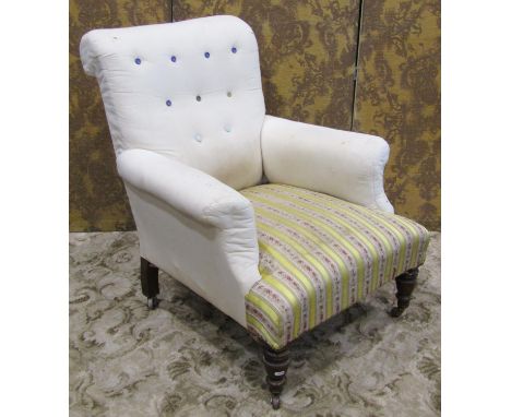 A late Victorian drawing room chair with swept arms and rolled button back raised on turned forelegs with brass caps and cera