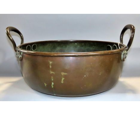 A 19th century patinated copper circular pan with loop handles, 38cm diameter