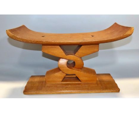 An Ashanti Wisdom Knot wooden stool, 43cm wide x 26.5cm high.